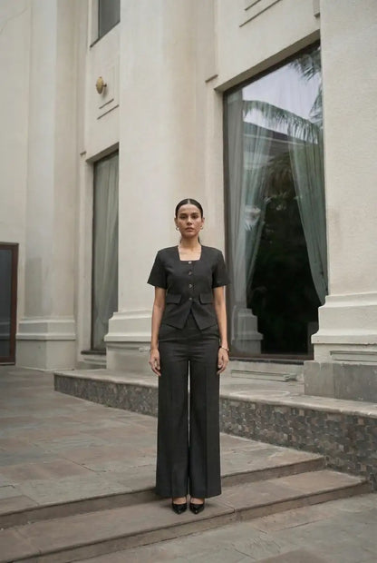 , MidWeek Women's Formal Wear - Workwear Style India, Woman in a black outfit standing on steps in front of a building entrance.
