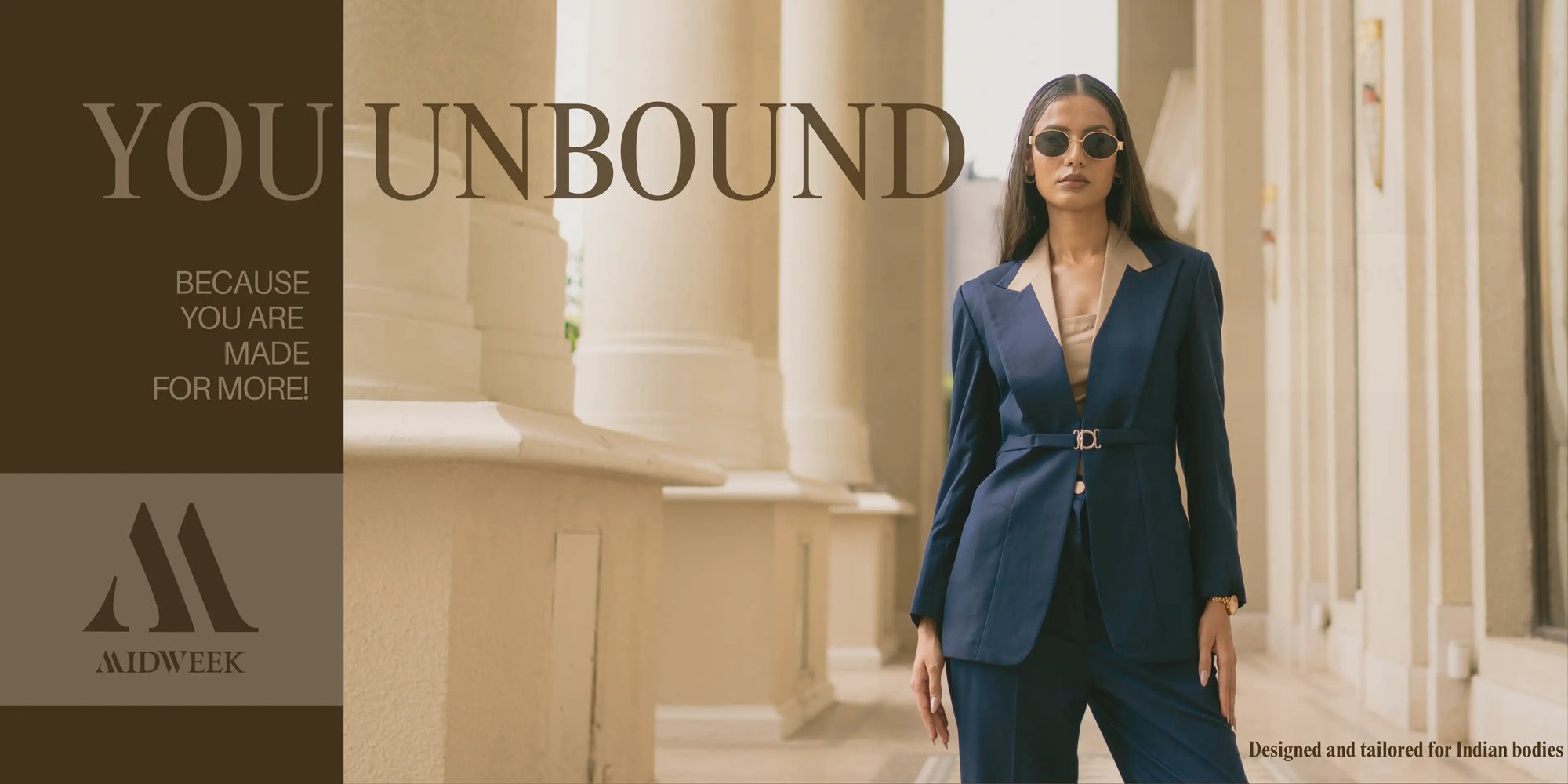 Woman in a navy suit standing in front of classical columns with 'You Unbound' text and Midweek logo.