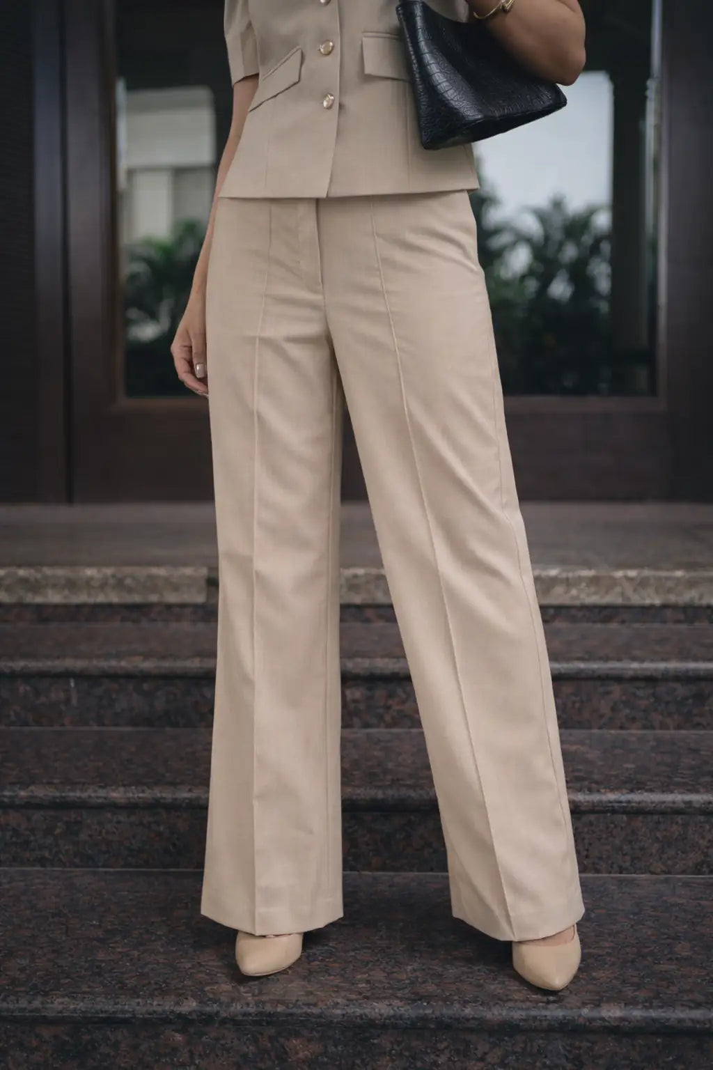 , MidWeek Women's Formal Wear - Workwear Style India, Person wearing a beige suit standing on steps with a blurred background