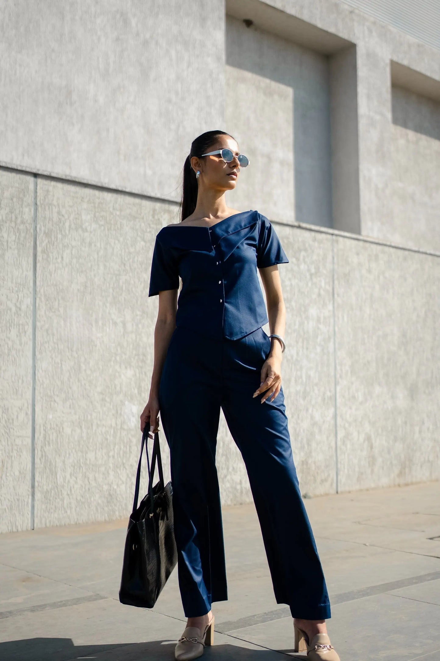 , MidWeek Women's Formal Wear - Workwear Style India, Woman in a navy outfit standing against a light gray wall.
