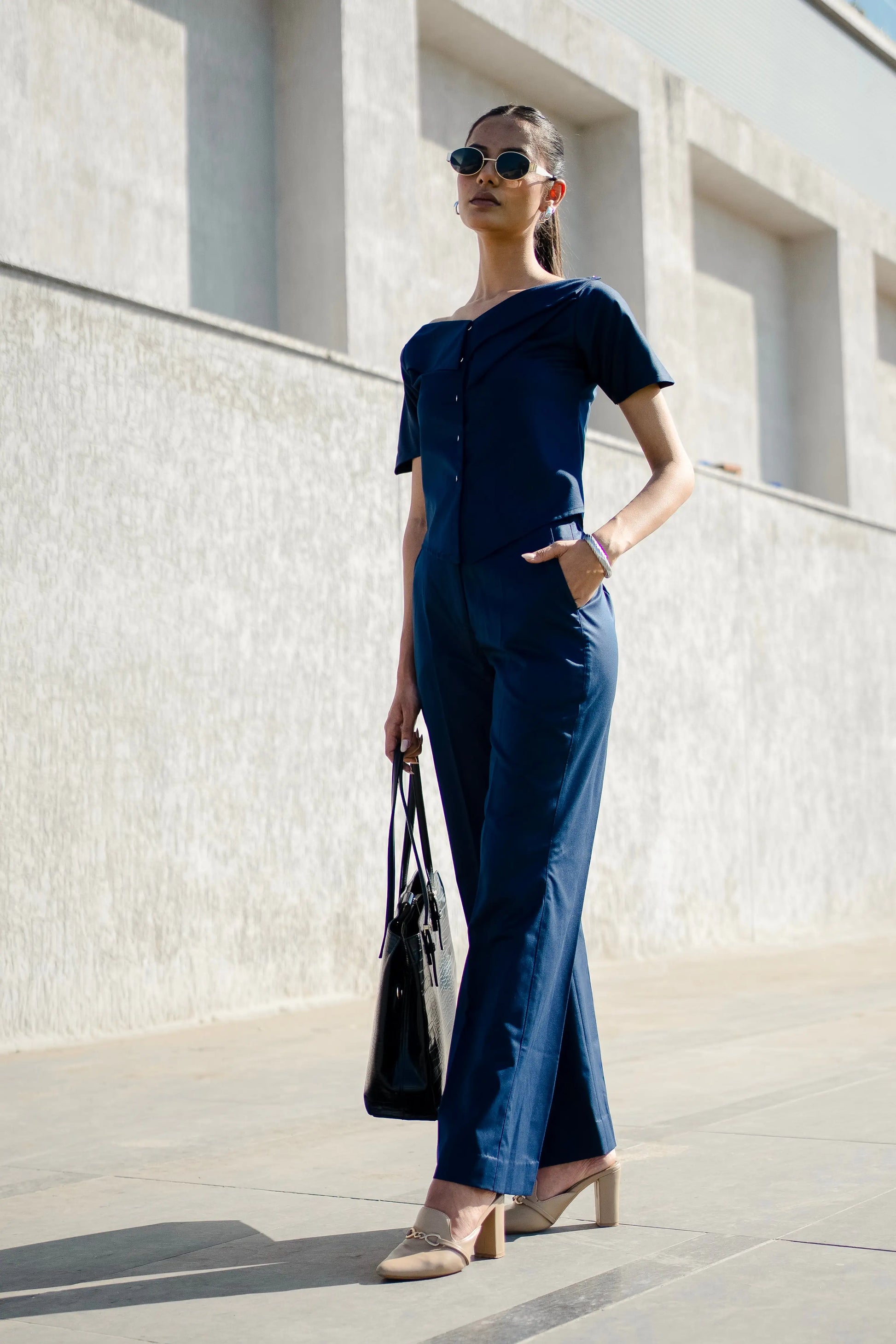 , MidWeek Women's Formal Wear - Workwear Style India, Woman in a navy blue outfit standing against a light-colored wall.