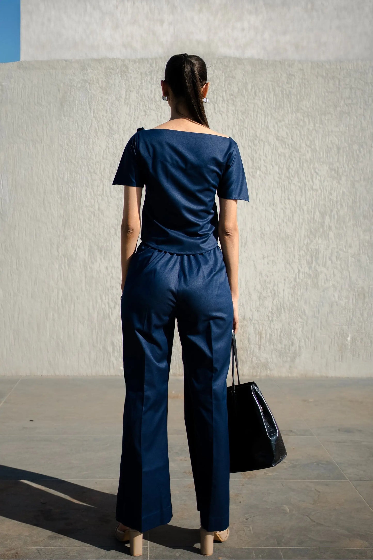 , MidWeek Women's Formal Wear - Workwear Style India, Woman wearing a navy blue outfit standing against a light-colored wall.