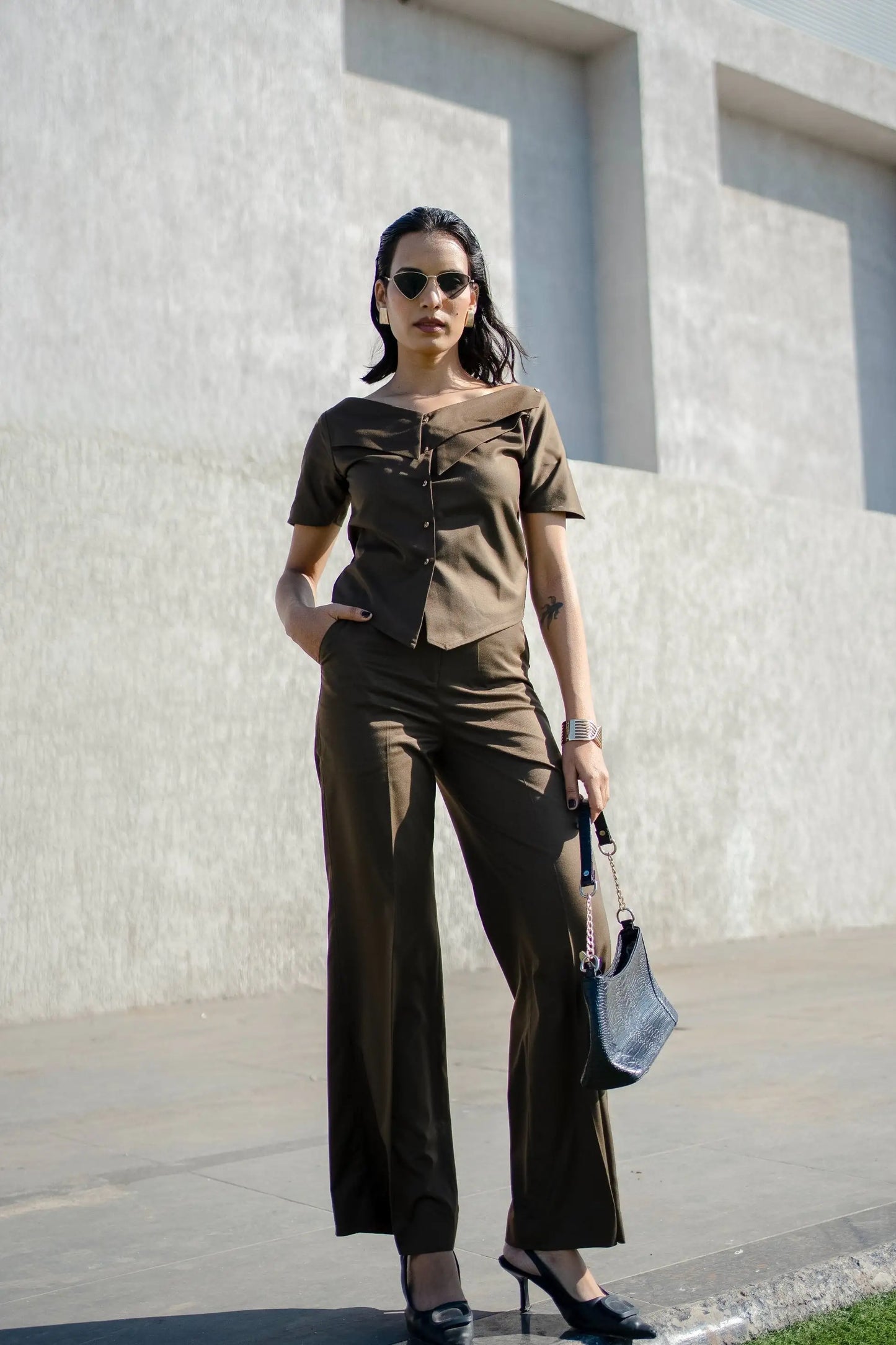 , MidWeek Women's Formal Wear - Workwear Style India, Woman in a brown outfit standing against a light-colored wall.