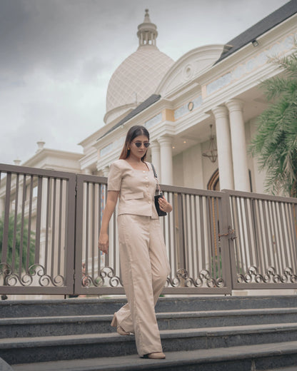 Mystic Sand Waistcoat & Pant Set, MidWeek Women's Formal Wear - Workwear Style India, Woman in a beige outfit walking on steps in front of a building with a dome.