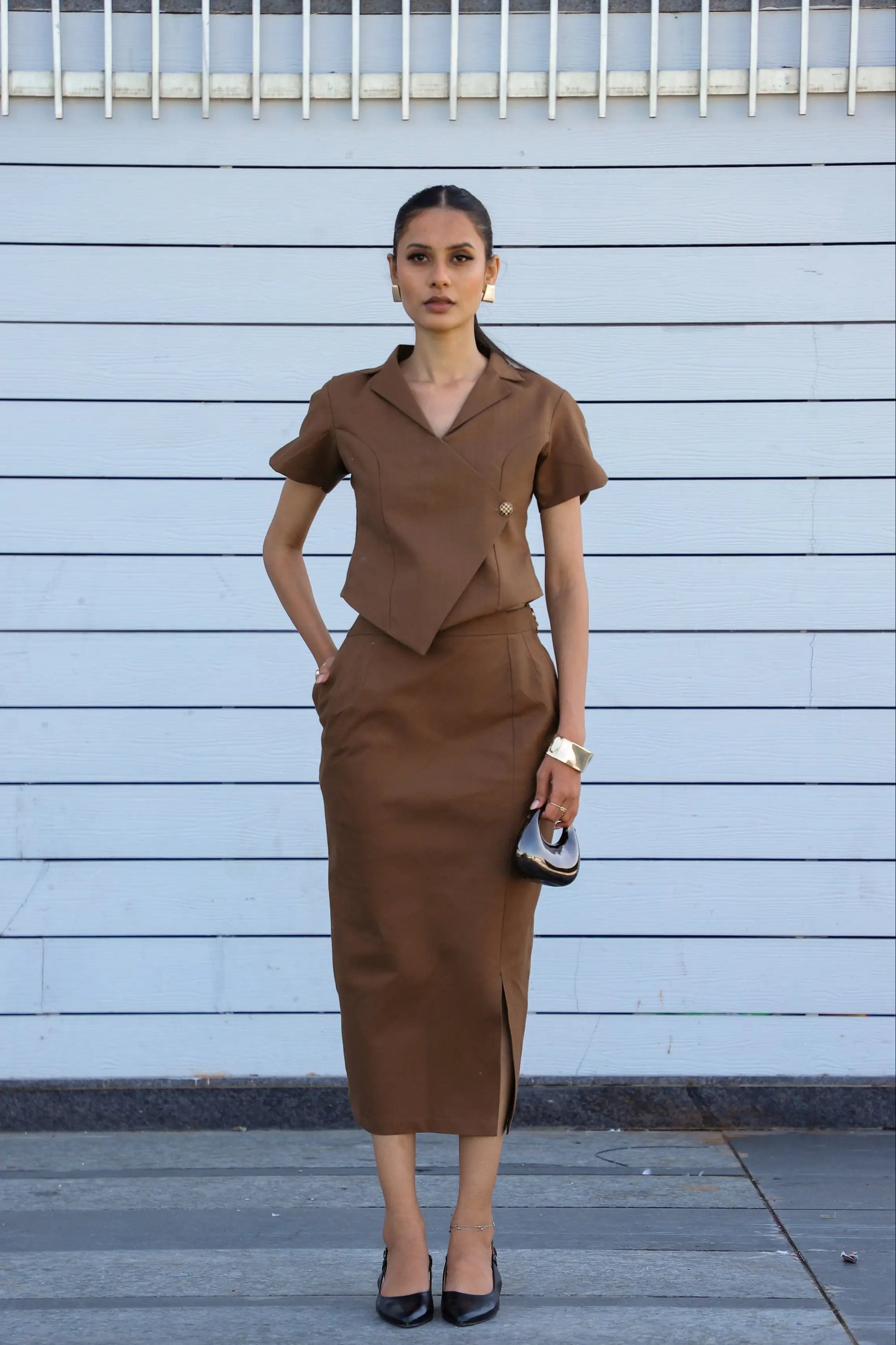 Curved Core Line Set, MidWeek Women's Formal Wear - Workwear Style India, Woman wearing a brown outfit against a light blue wall.