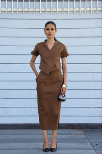 Curved Core Line Set, MidWeek Women's Formal Wear - Workwear Style India, Woman wearing a brown outfit against a light blue wall.