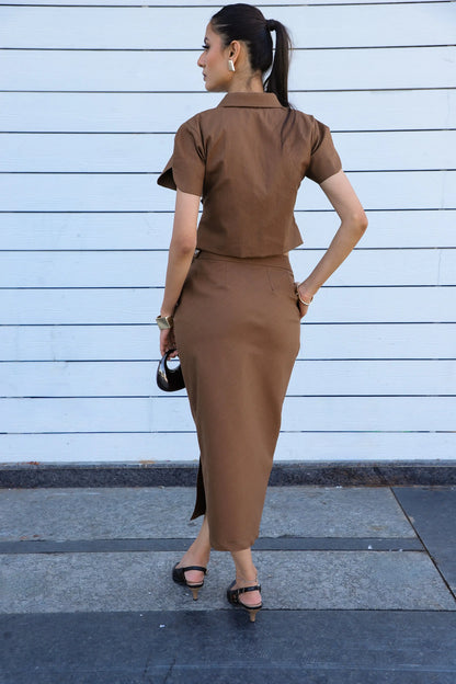 , MidWeek Women's Formal Wear - Workwear Style India, Woman in a brown outfit standing against a light blue wall.