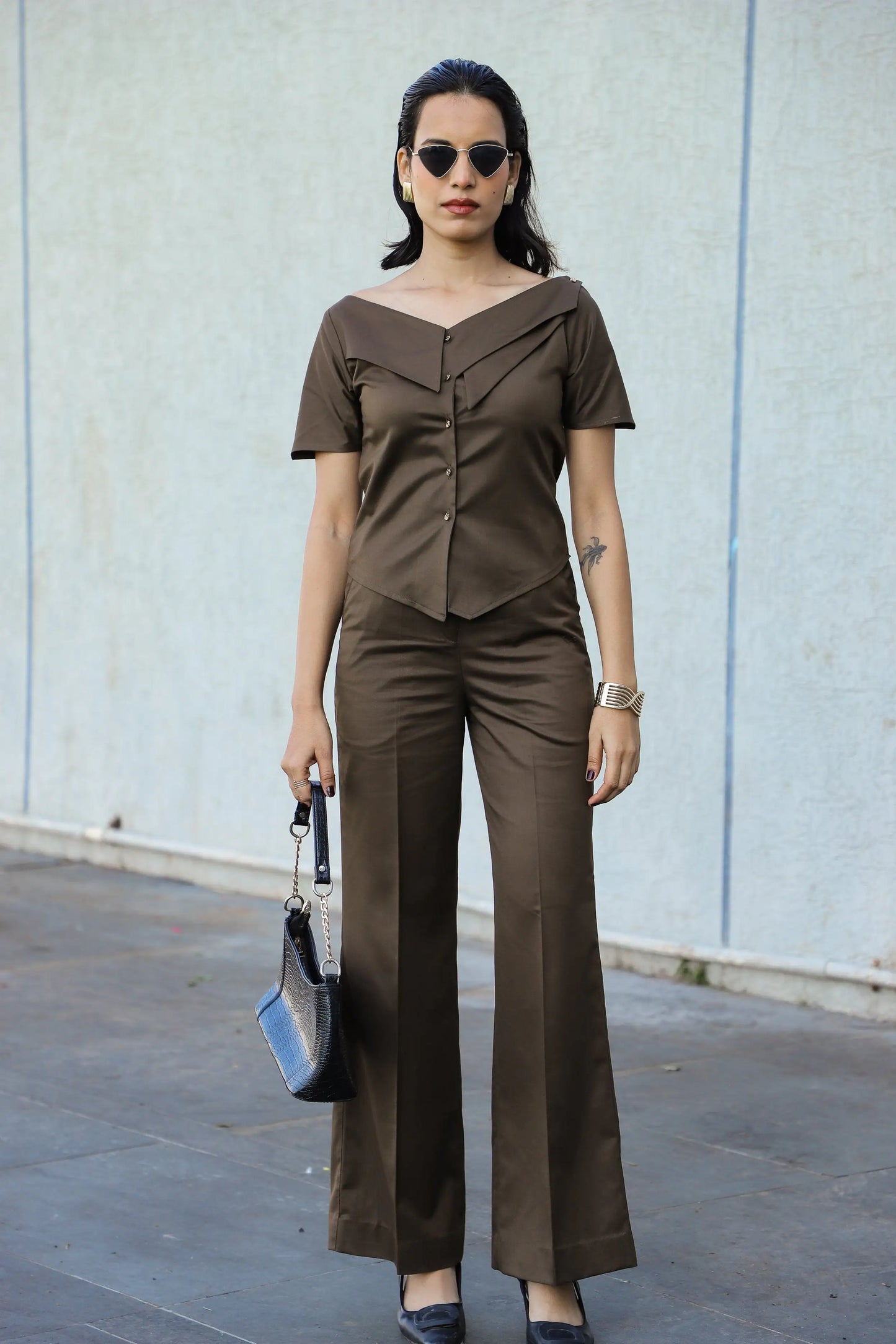 , MidWeek Women's Formal Wear - Workwear Style India, Woman in a brown outfit standing against a light gray wall.