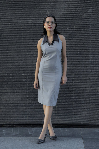 , MidWeek Women's Formal Wear - Workwear Style India, Woman wearing a gray dress with a black collar against a dark textured wall.