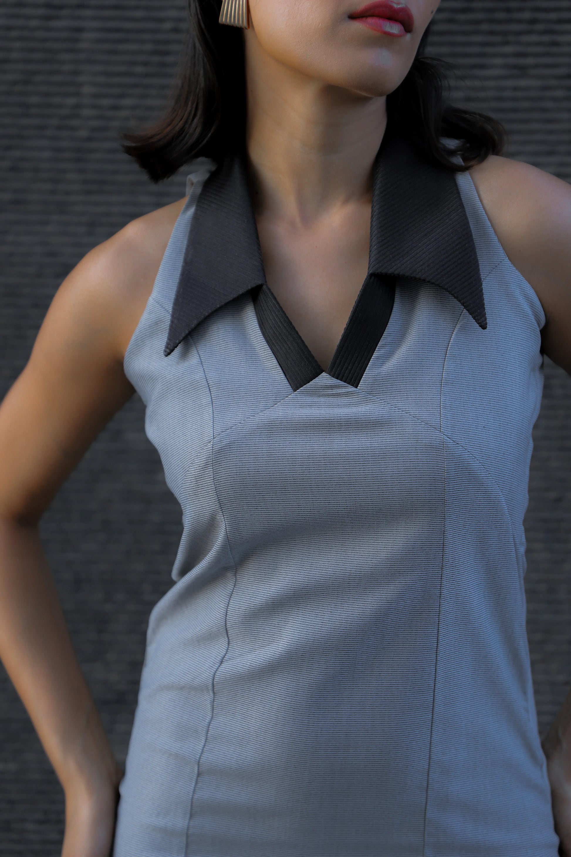 , MidWeek Women's Formal Wear - Workwear Style India, Woman wearing a sleeveless gray dress with a black collar against a dark background