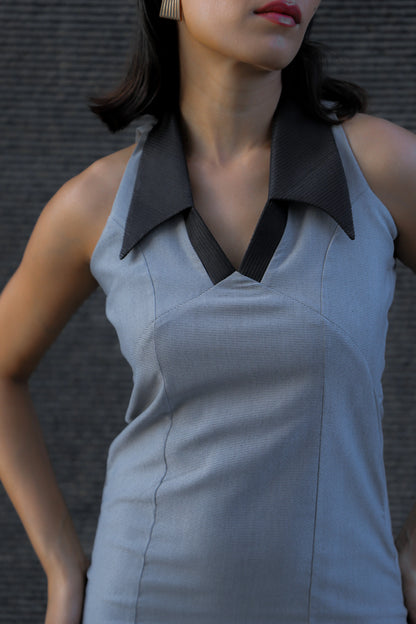 , MidWeek Women's Formal Wear - Workwear Style India, Woman wearing a sleeveless gray dress with a black collar against a dark background